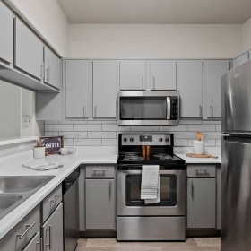 Ample lighting inside apartment c-shaped kitchen at Stone Canyon  
