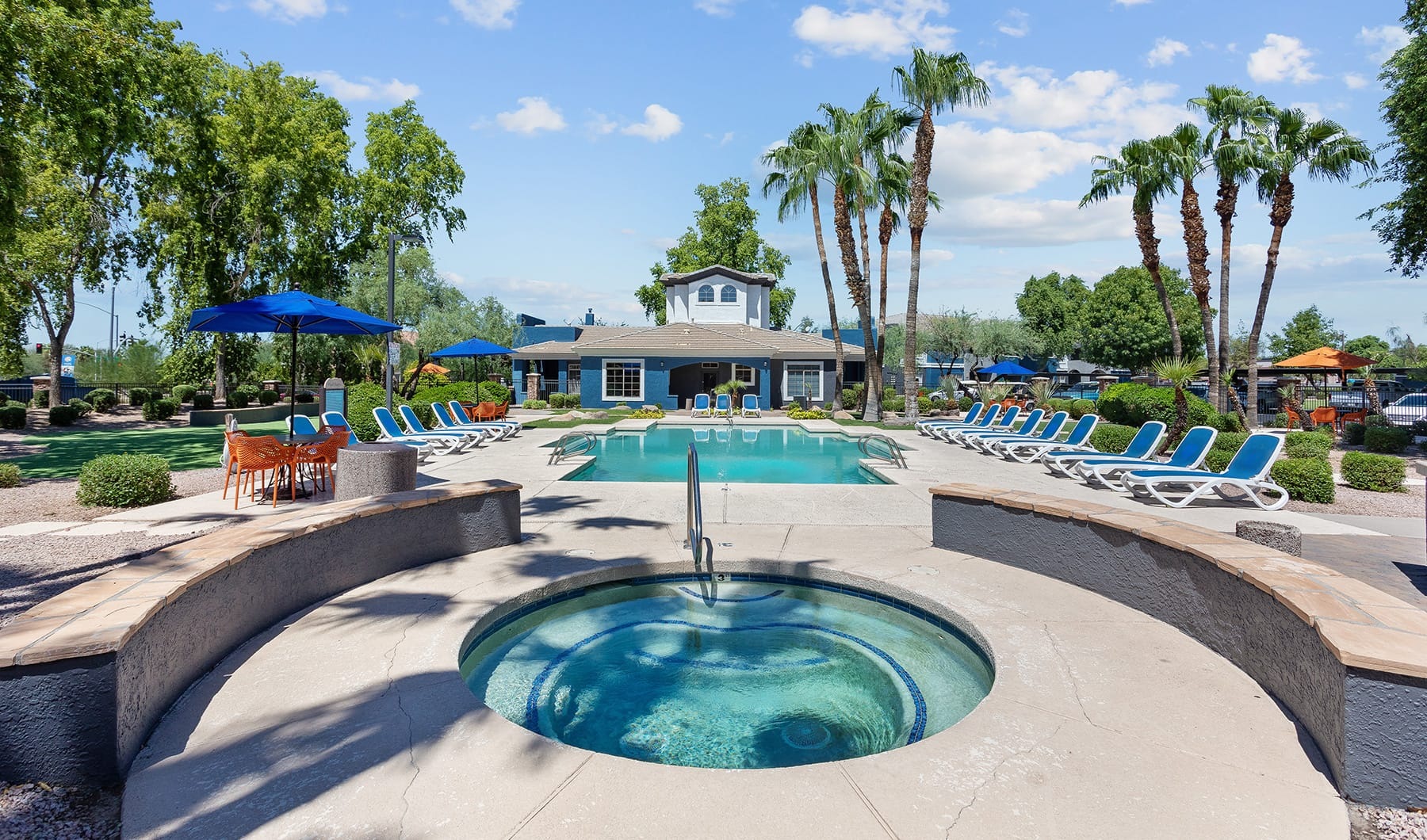 Stone Canyon jacuzzi and pool with reclining seats on pool deck